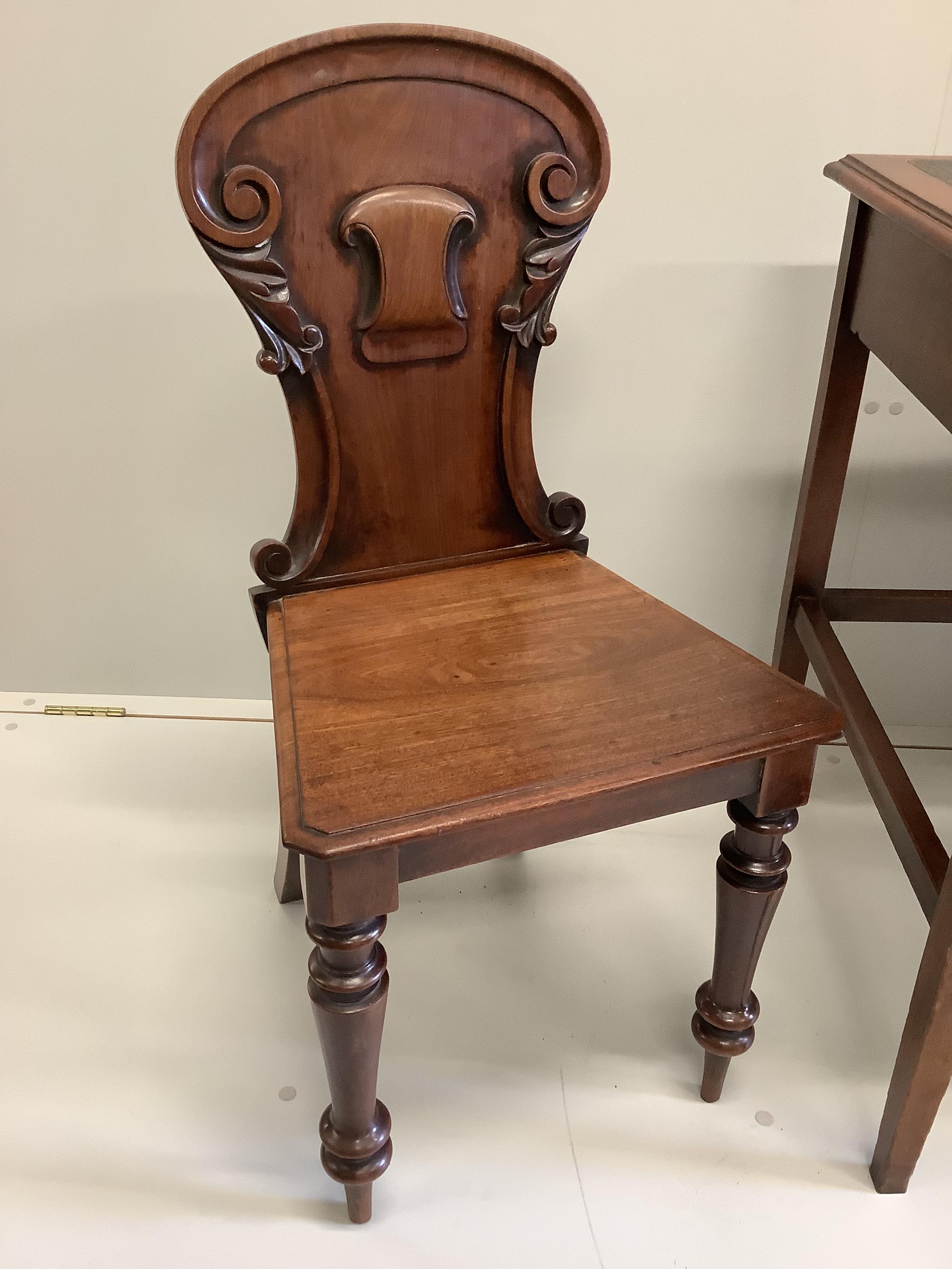 An early 20th century mahogany and beech four drawer kneehole writing desk, width 107cm, depth 60cm, height 75cm, together with a Victorian mahogany hall chair